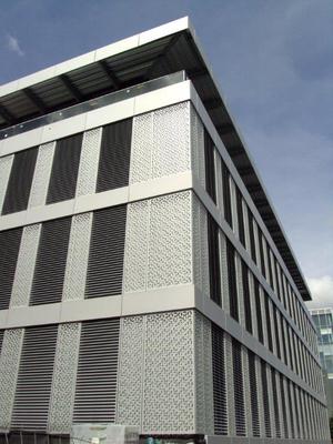 Lochblechfassade nach Maß mit einer Sonderlochung (in Hufeisen-Form), für ein Bürogebäude in der Lausanne, Schweiz